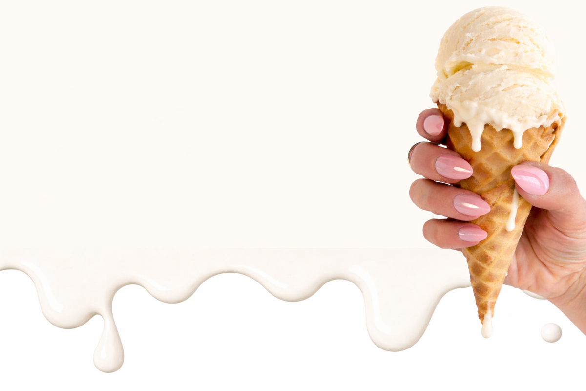Hand holding a melting ice cream cone with white background